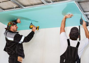 Plasterboard installers. Men assembling a drywall false ceiling.Simple and affordable renovation of premises